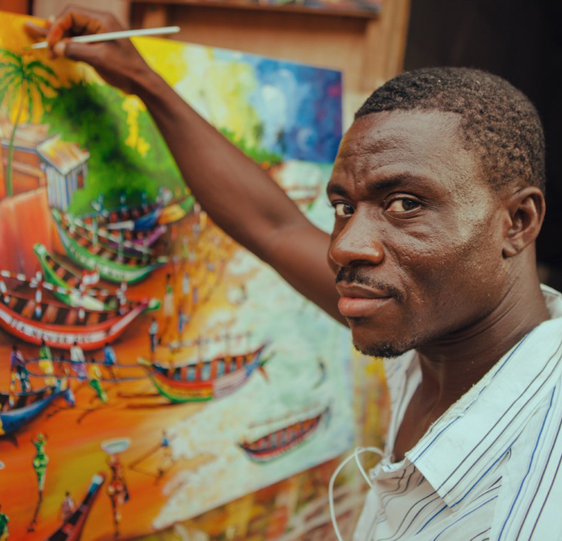 Talented black man drawing picture with brush on street